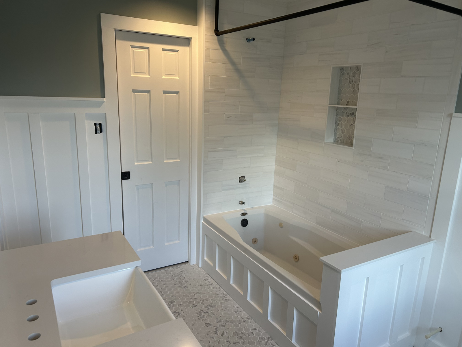 Bright bathroom remodel with tiled shower and soaking tub