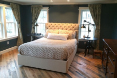 Completed bedroom addition with custom headboard and hardwood floors