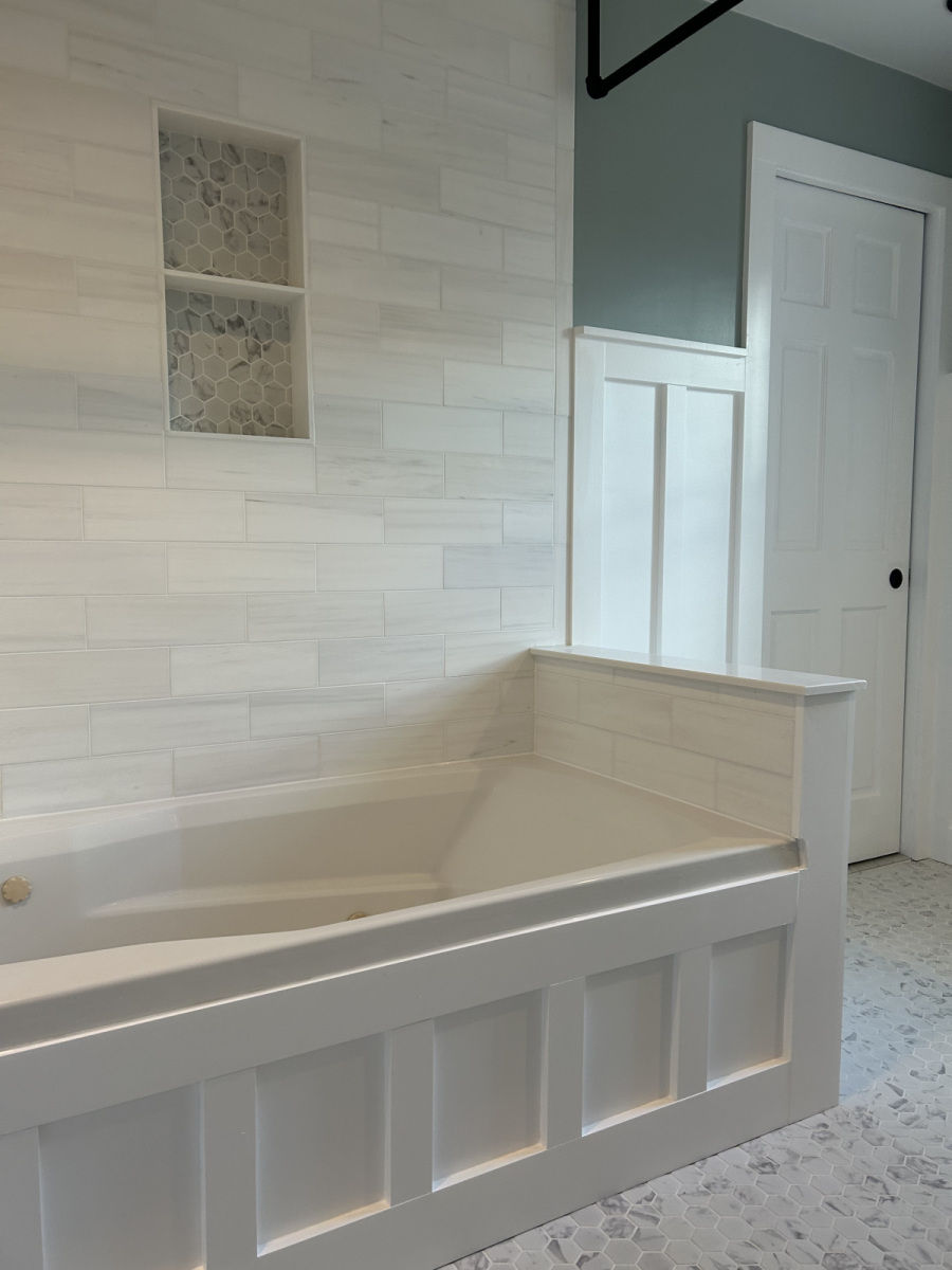 Custom bathroom tub surround with decorative wall paneling