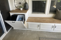 Built-in window seat with shaker doors, butcher-block top, and hidden storage