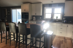 Kitchen island with bar seating and stainless appliances