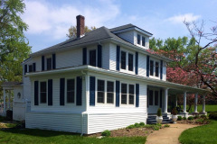Renovated two-story home exterior with new windows and trim