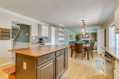 Kitchen island with butcher block top opening to dining area