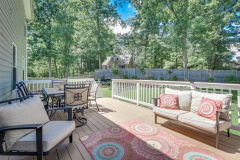 Backyard deck with outdoor dining set and lounge seating