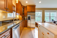 Cherry cabinet kitchen with granite counters and stainless appliances
