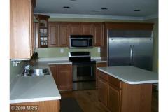 Cherry cabinet kitchen with island and stainless appliances (before remodel)