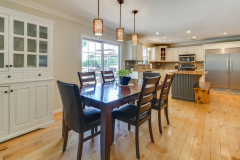 Dining room with pendant lighting opening to remodeled kitchen