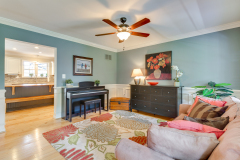 Open living room with refinished hardwood floors and updated finishes