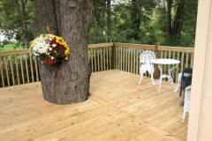 Wraparound cedar deck around a tree with bistro seating
