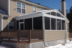 Screened-in porch addition on raised deck with white frame